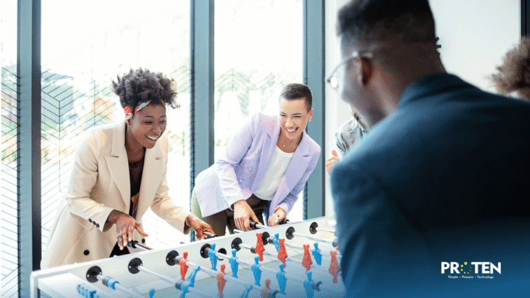 Team members playing table football