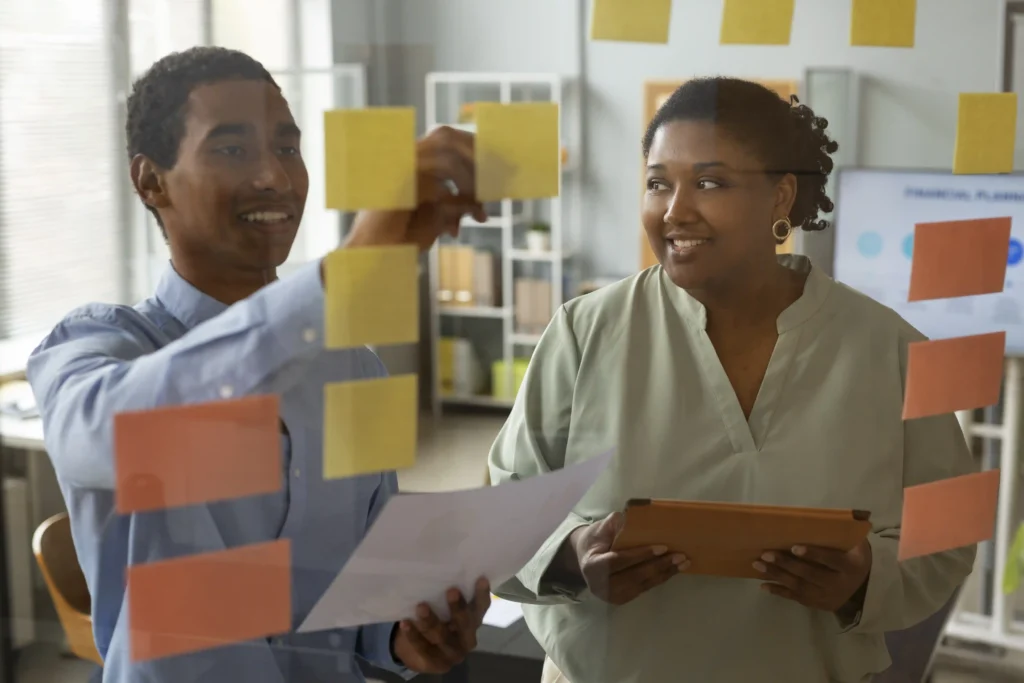 front view smiley people working with post its