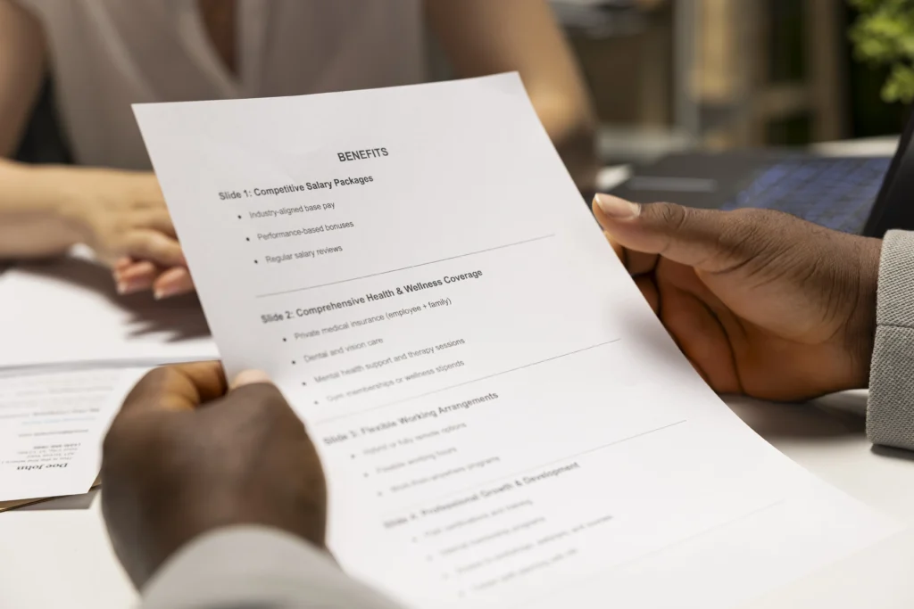 close up black man reads monthly perks salary options meeting with recruiter discuss