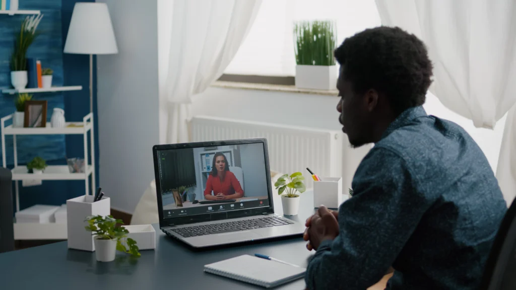 african american man remote worker working from home taking online office call with partners colleagues greeting them computer user from home office video internet conference via webcam confe