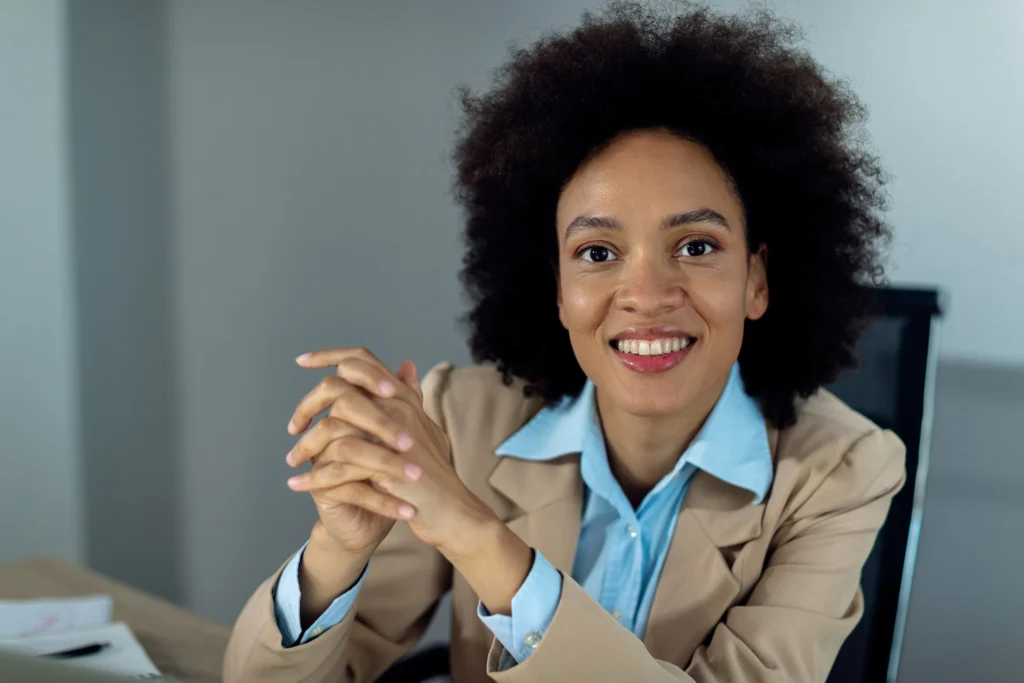 happy african american businesswoman working office looking camera