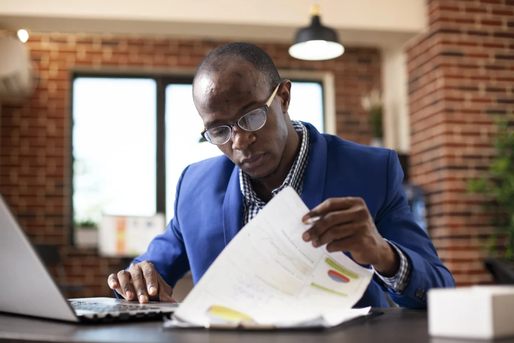 male manager reviewing data clipboard